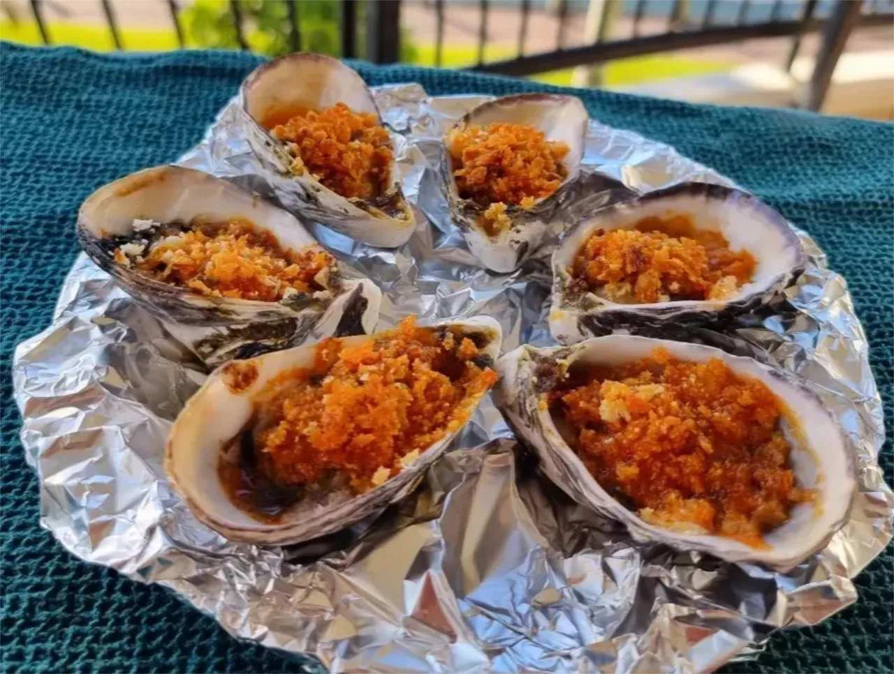 6 grilled nduja oysters on a serving plate