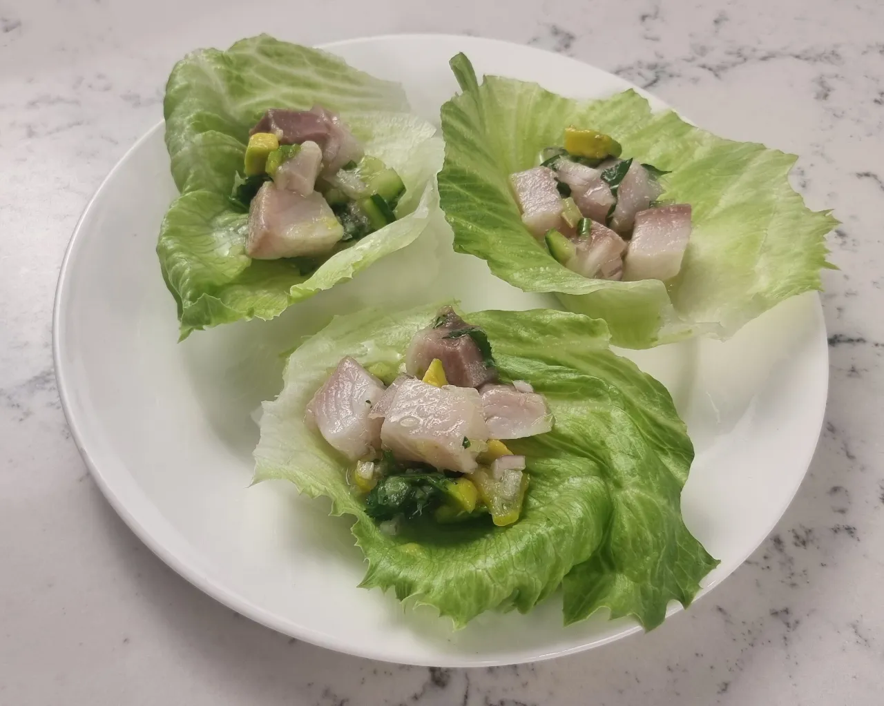 Serve lemon drop chilli kingfish ceviche in lettuce cups